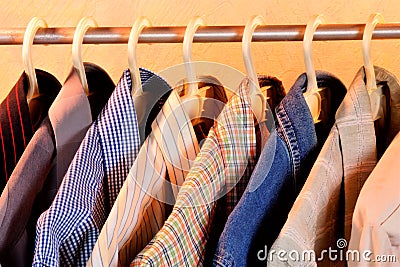 Colored shirts on the hanger, type of men`s and women`s clothing, underwear. Stock Photo